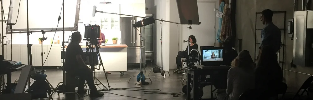 A TVCG crew filming a commercial on a kitchen set