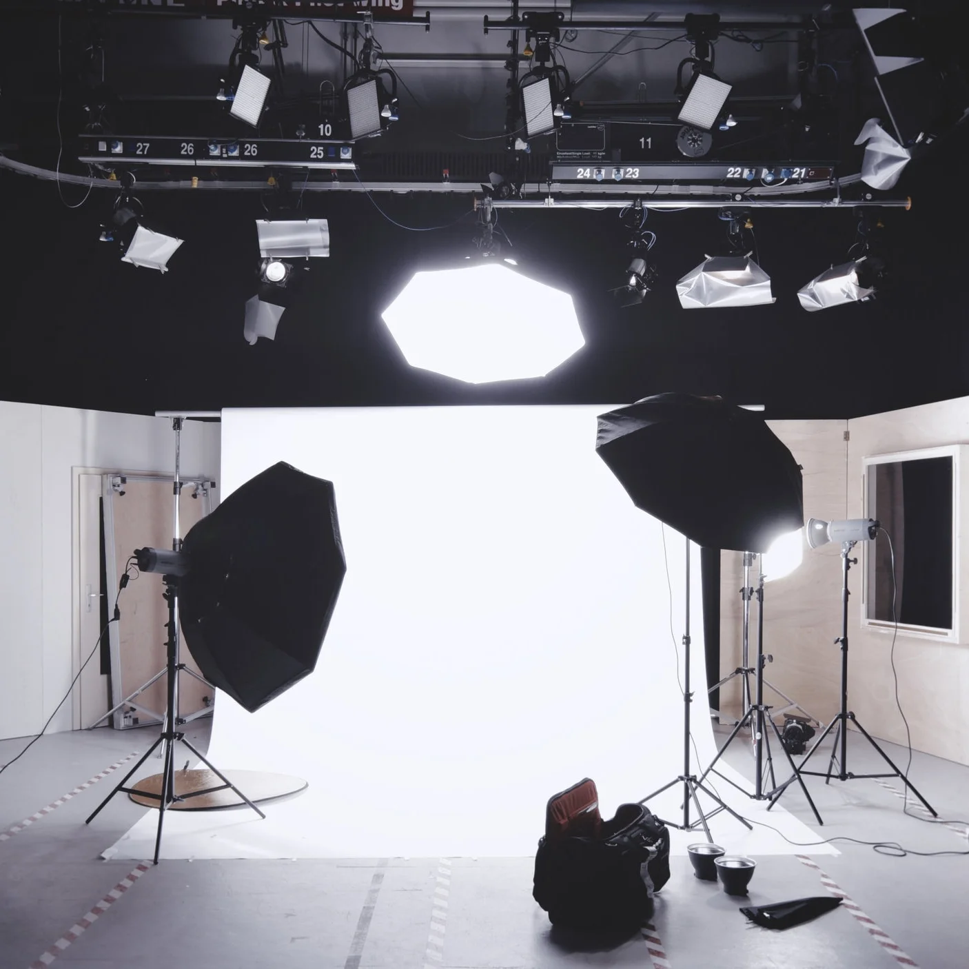 A lit production studio with softboxes and a white cyclorama